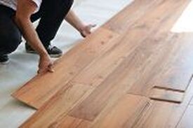 Installer installing hardwood floors 